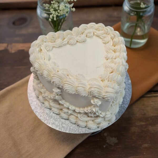 Juliette heart-shaped wedding cake with ivory piped buttercream shells